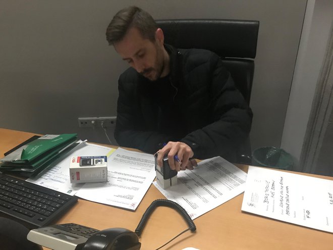 Tajnik občinske volilne komisije Alan Žiberna z žigom potrjuje prejem ugovora. FOTO: Moni Černe