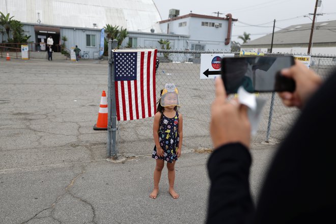 Carol Chang je volil v Kaliforniji, nato pa to obeležil s fotografijo hčerke. FOTO: Lucy Nicholson, Reuters