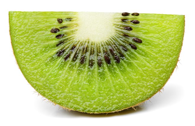 Front view of ripe slice of kiwi fruit isolated on white background