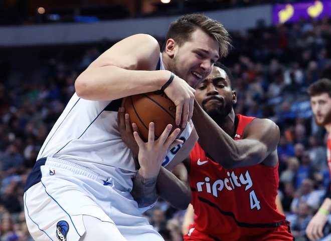 Feb 10, 2019; Dallas, TX, USA; Dallas Mavericks forward Luka Doncic (77) and Portland Trail Blazers forward Maurice Harkless (4) battle for the ball during the first quarter at American Airlines Center. Mandatory Credit: Kevin Jairaj-USA TODAY Sports