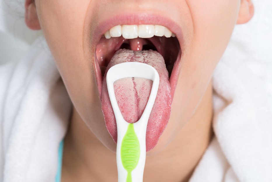 Fotografija: Pri ščetkanju zob ne pozabite na jezik. FOTO: Thinkstock