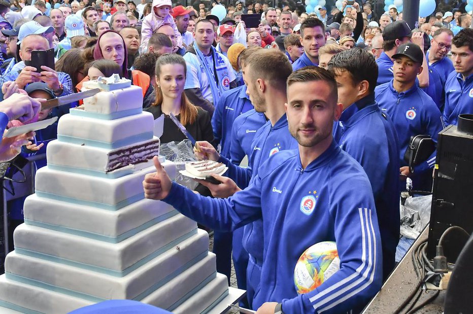 Fotografija: Andraž Šporar se je z veseljem stisnil k torti, ki je bila del praznovanja stoletnice Slovana iz Bratislave. FOTO: Slovan Bratislava