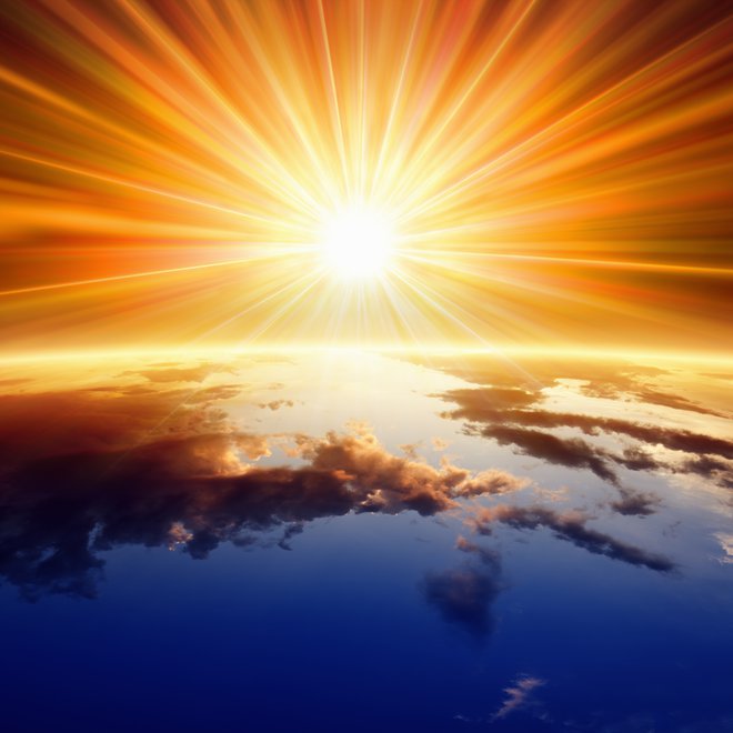 Abstract religious backgrounf - bright sun shines above planet Earth