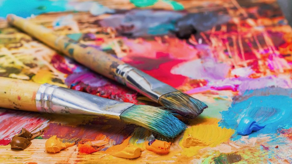 Fotografija: Used brushes on an artist's palette of colorful oil paint for drawing and painting