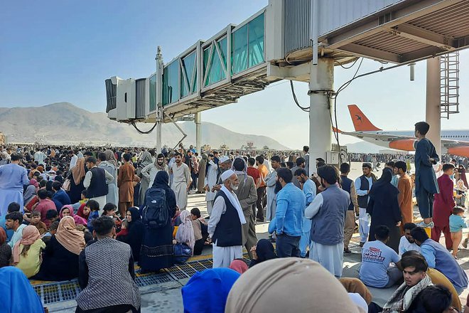 Na tisoče ljudi se je zgrnilo na letališče in poskuša najti izhod iz države. Posnetki kažejo ogromno množico ljudi na ploščadi na letališču, kjer letala običajno vkrcavajo potnike. FOTO: AFP