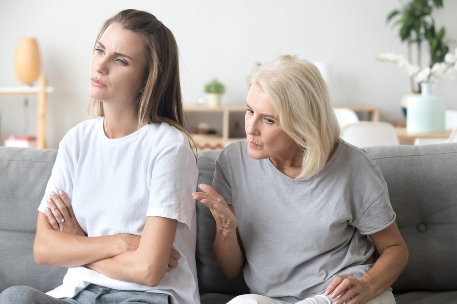 Fotografija: Controlling elderly mother scolding adult daughter having serious conversation with her, stubborn young woman sit back to mom, not listening to strict aged parent lecturing her or giving advice
