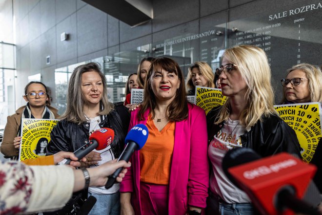Justyna Wydrzynska (v sredini) v družbi aktivistk za pravice žensk Natalie Broniarczyk in Kinge Jelinske govori z novinarji pred sodno dvorano. FOTO: Wojtek Radwanski/AFP
