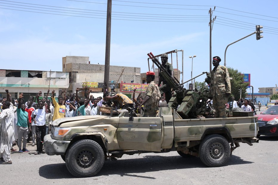 Fotografija: Prebivalci rdečemorskega mesta Port Sudan pozdravljajo vladne vojake. FOTO: AFP