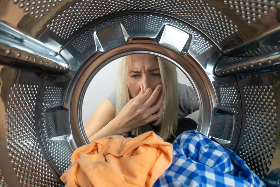 Fotografija: Neprijeten vonj v pralnem stroju je lahko posledica nakopičenih ostankov pralnih sredstev in umazanije, včasih je zanj krivo dejstvo, da v njem predolgo čaka oprano perilo.FOTO: Olga Ihnatsyeva, Gettyimages