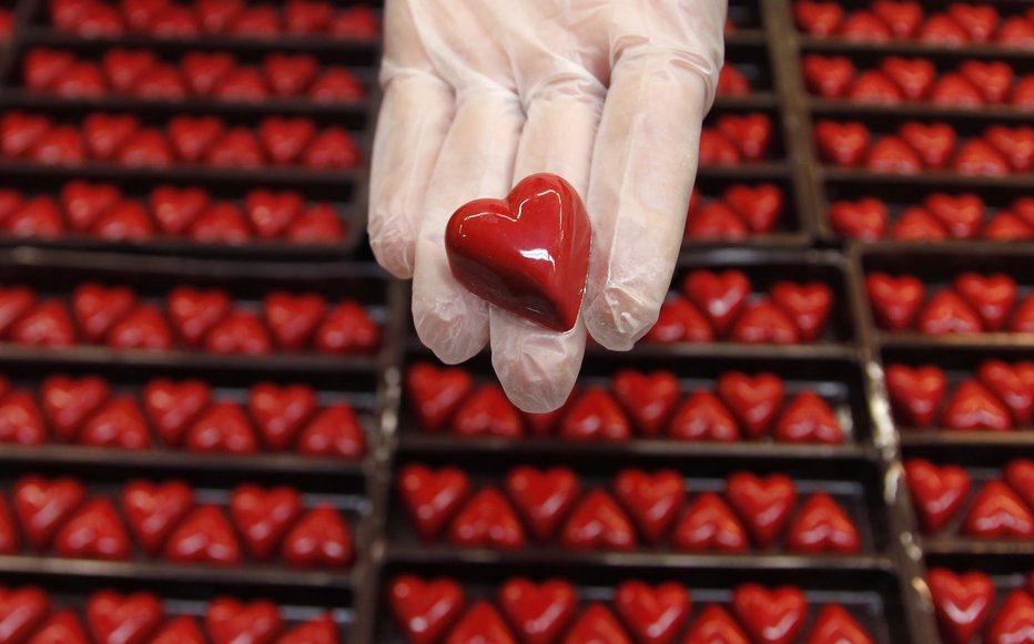 Fotografija: A worker displays a heart-shaped praline for Valentine's Day at a Wittamer chocolate boutique in Brussels February 14, 2012. REUTERS/Francois Lenoir (BELGIUM - Tags: FOOD SOCIETY) - RTR2XTWN [avtor:© Francois Lenoir/Reuters] FOTO: Š Francois Lenoir/Reuters Reuters Pictures