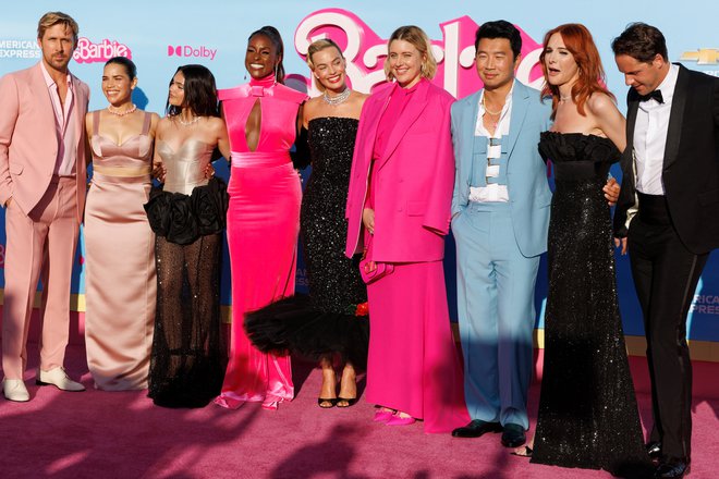 Actor Simu Liu (in blue suit) poses next to director Greta Gerwig and the cast of the film 