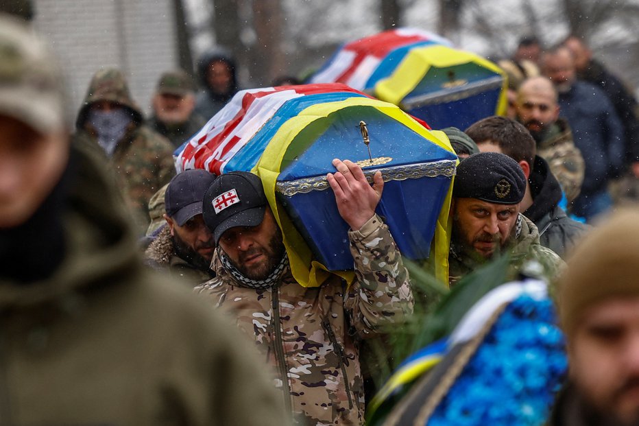 Fotografija: Po Ukrajini je po neuradnih podatkih včasih okoli tisoč vojaških pogrebov na dan. FOTO: Valentyn Ogirenko, Reuters
