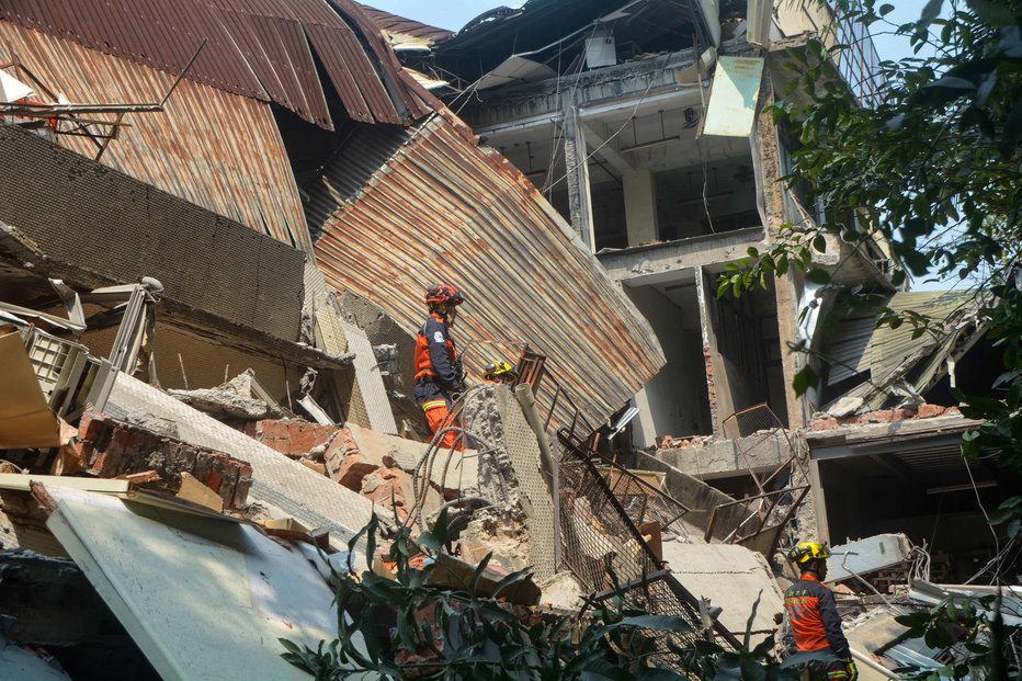 Fotografija: Zaradi potresa se je delno porušilo več stavb, gasilci iz njih še vedno rešujejo ljudi. Več sto je ranjenih, najmanj sedem jih je umrlo. FOTO: Afp